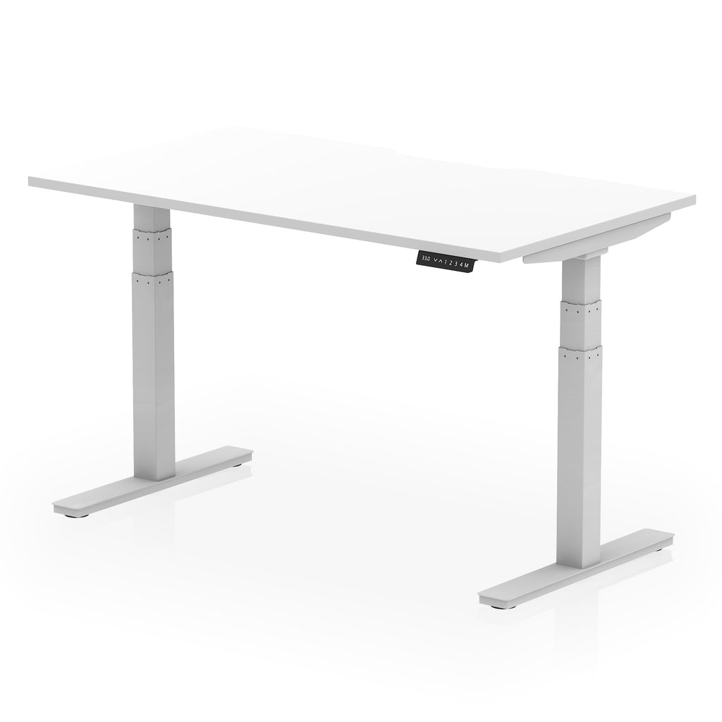 Height adjustable desk with white top and silver frame on a white background