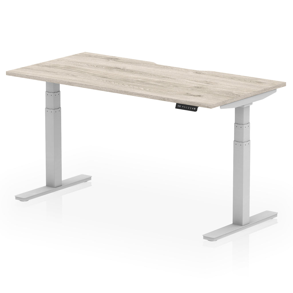 Height adjustable desk with wood-effect top and silver frame on a white background
