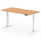 Height adjustable desk with wood-effect top and white frame on a white background