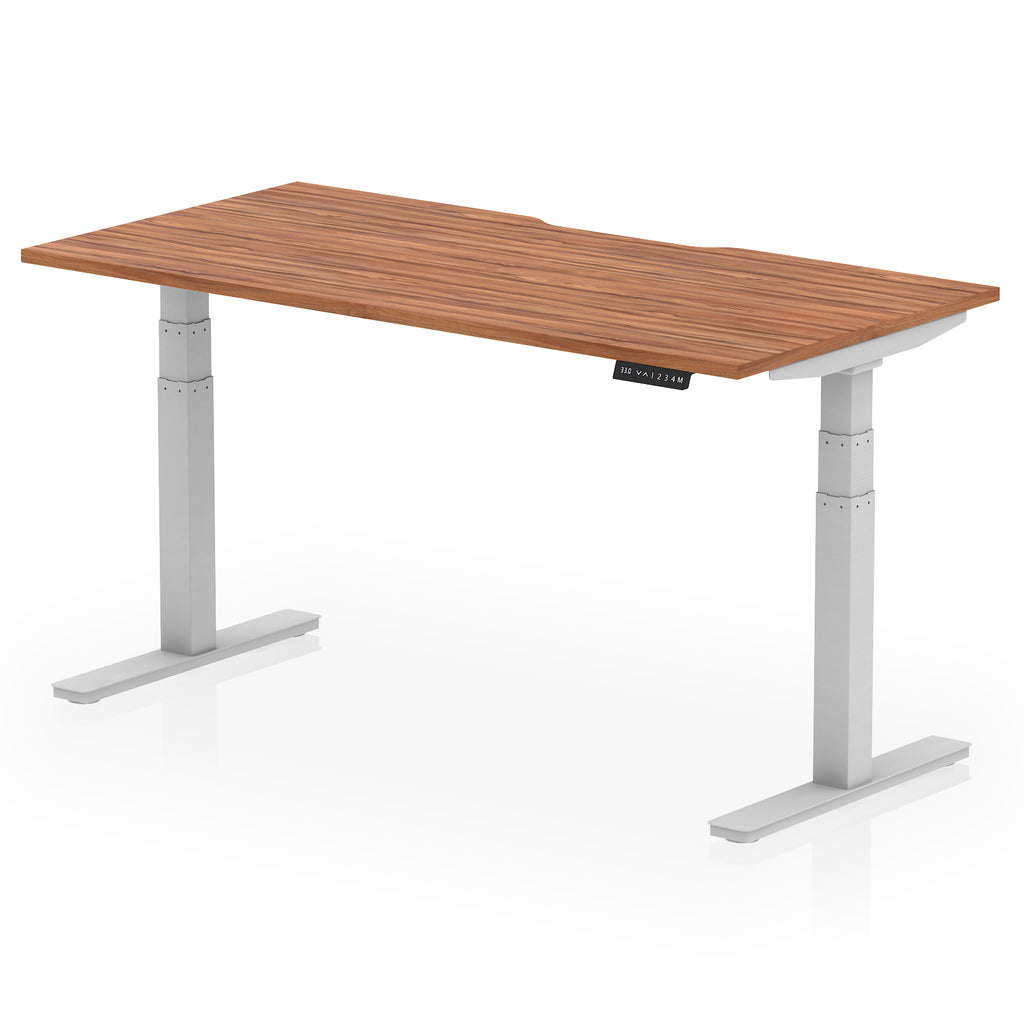 Height adjustable desk with wood-effect top and silver frame on a white background