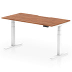 Height adjustable desk with wood-effect top and white frame on a white background