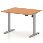 An adjustable height standing desk with a light brown wood-grain desktop and a silver metal frame, shown on a white background.