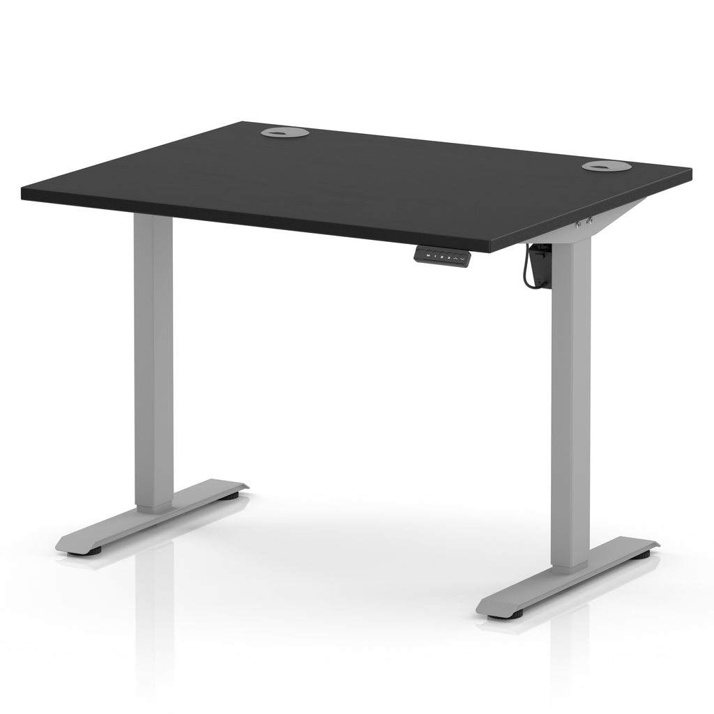 An electric height-adjustable standing desk with a black rectangular desktop and a silver metal frame, shown on a clean white background.