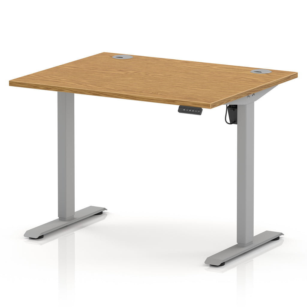 An adjustable height standing desk with a light oak wood grain top and a silver metal frame, shown on a white background.