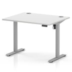 An adjustable height standing desk with a white tabletop and silver metal legs, shown on a clean white background.