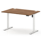An adjustable height standing desk with a brown wood-grain top and white metal legs, shown on a clean white background.