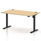 An adjustable height standing desk with a light oak wood grain top and black metal legs, shown on a clean white background.