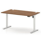An adjustable height standing desk with a brown wood-grain desktop and white metal legs, shown on a clean white background.