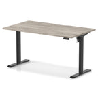 Height adjustable desk with grey wood-effect top and black frame on a white background
