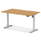 Height adjustable desk with wood-effect top and silver frame on a white background