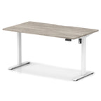 Height adjustable desk with grey wood-effect top and white frame on a white background