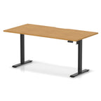 Height adjustable desk with wood-effect top and black frame on a white background