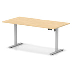 Height adjustable desk with wood-effect top and silver frame on a white background