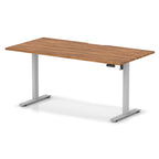 Height adjustable desk with wood-effect top and silver frame on a white background