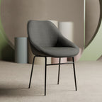 Grey chair with black legs in a minimalistic setting