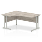  L-shaped desk with wood-effect top and metal legs on a white background
