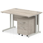 Grey wood-effect office desk with a matching pedestal unit and a metal frame on a white background