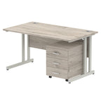 Grey wood-effect office desk with a matching pedestal unit and a metal frame on a white background