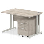 Grey wood-effect office desk with a matching pedestal unit and a metal frame on a white background