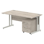 Grey wood-effect office desk with a matching pedestal unit and a metal frame on a white background
