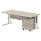 Grey wood-effect office desk with a matching pedestal unit and a metal frame on a white background