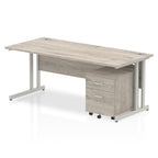 Grey wood-effect office desk with a matching pedestal unit and a metal frame on a white background