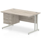 Grey wood-effect office desk with fixed pedestal and metal legs on a white background