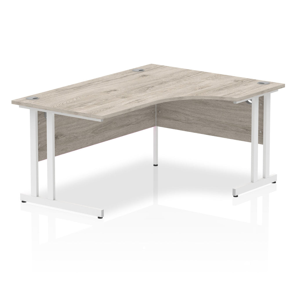 Grey wood-effect L-shaped desk with metal legs on a white background
