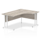 Grey wood-effect L-shaped desk with metal legs on a white background