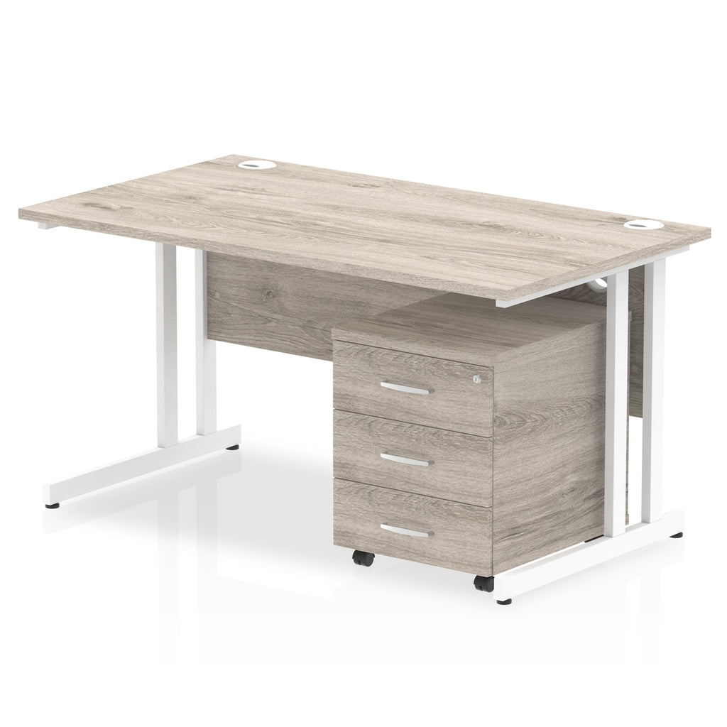 Grey wood-effect office desk with a matching pedestal unit and a metal frame on a white background