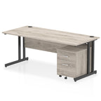 Grey wood-effect office desk with a matching pedestal unit and a metal frame on a white background