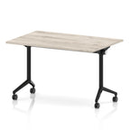 Rectangular table with a grey wood-effect flip top and black metal legs on wheels against a white background
