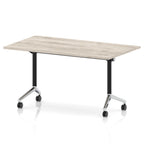 Rectangular table with a grey wood-effect flip top and black and chrome metal legs on wheels against a white background