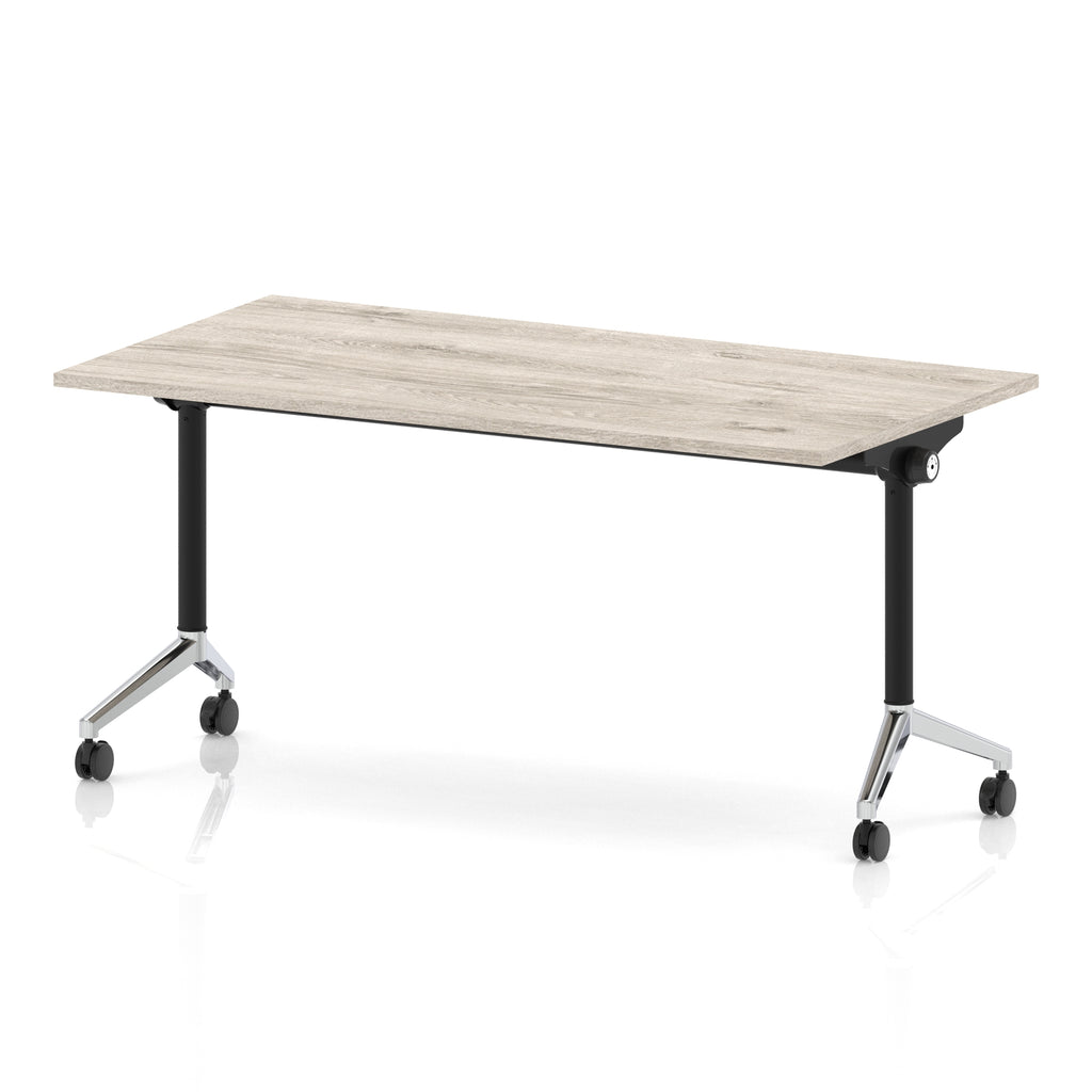 Rectangular table with a grey wood-effect flip top and black and chrome metal legs on wheels against a white background