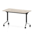 Rectangular table with a grey wood-effect top and black metal legs on wheels against a white background