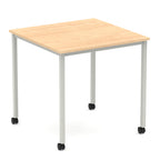 Square table with a wood-effect top and metal legs with castors on a white background