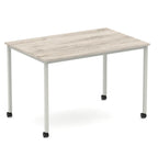 Rectangular table with a wood-effect top and metal legs with castors on a white background
