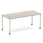 Rectangular table with a wood-effect top and metal legs with castors on a white background