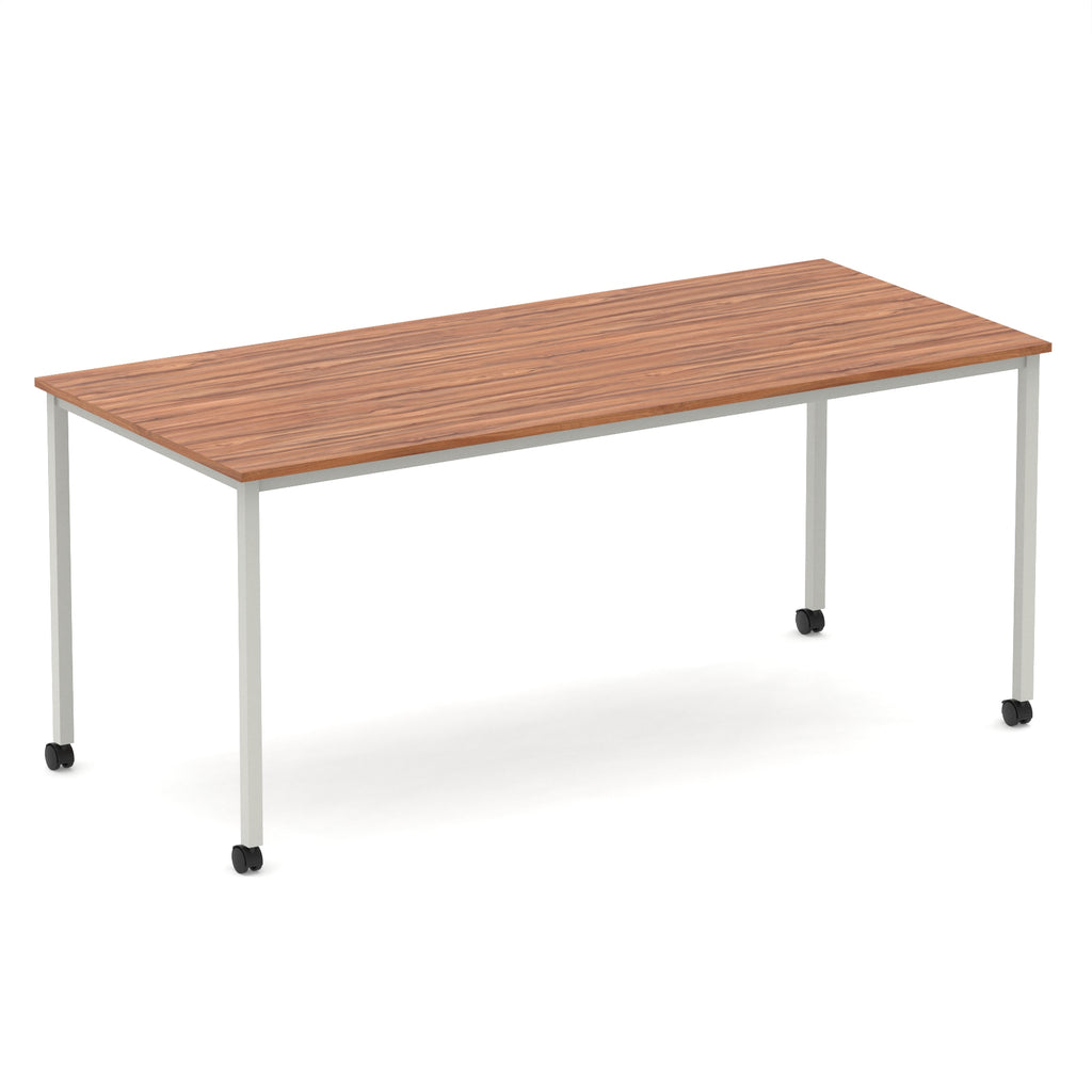 Rectangular table with a wood-effect top and metal legs with castors on a white background