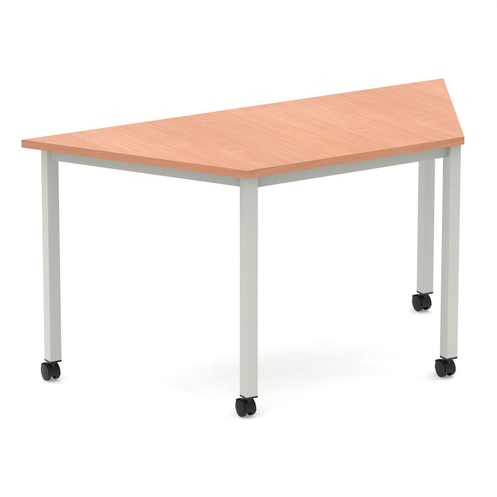 Trapezium shaped table with wood-effect top and metal frame with wheels, shown on a white background