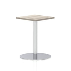 Square table with a grey wood-effect top and silver cylindrical base on a white background