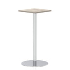 Square high table with a grey wood-effect top and silver cylindrical base on a white background