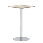Square high table with a grey wood-effect top and silver cylindrical base on a white background