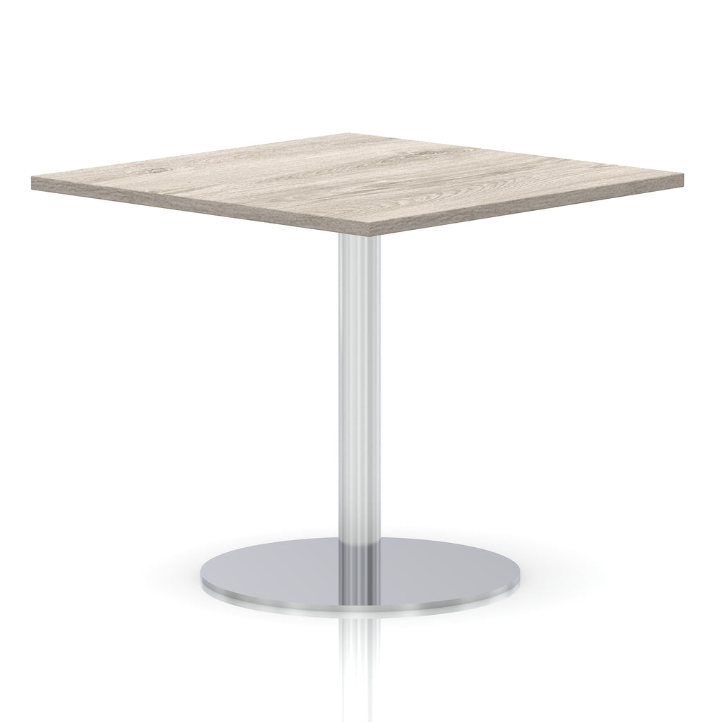 Square table with a grey wood-effect top and silver cylindrical base on a white background