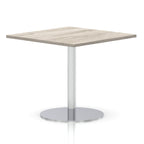 Square table with a grey wood-effect top and silver cylindrical base on a white background