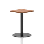 Square table with a wood-effect top and black cylindrical base on a white background