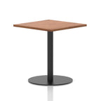Square table with a wood-effect top and black cylindrical base on a white background