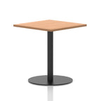 Square table with a wood-effect top and black cylindrical base on a white background