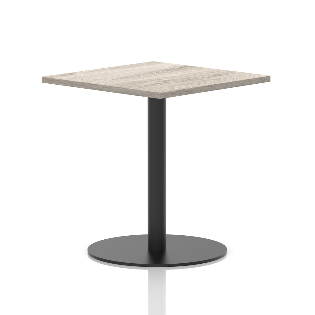 Square table with a grey wood-effect top and black cylindrical base on a white background
