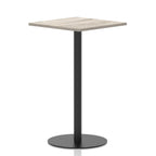 Square high table with a grey wood-effect top and black cylindrical base on a white background